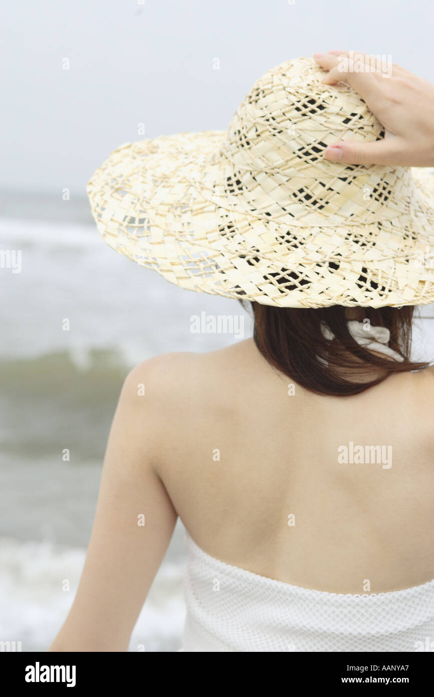 A young woman wearing a hat in beach Stock Photo - Alamy