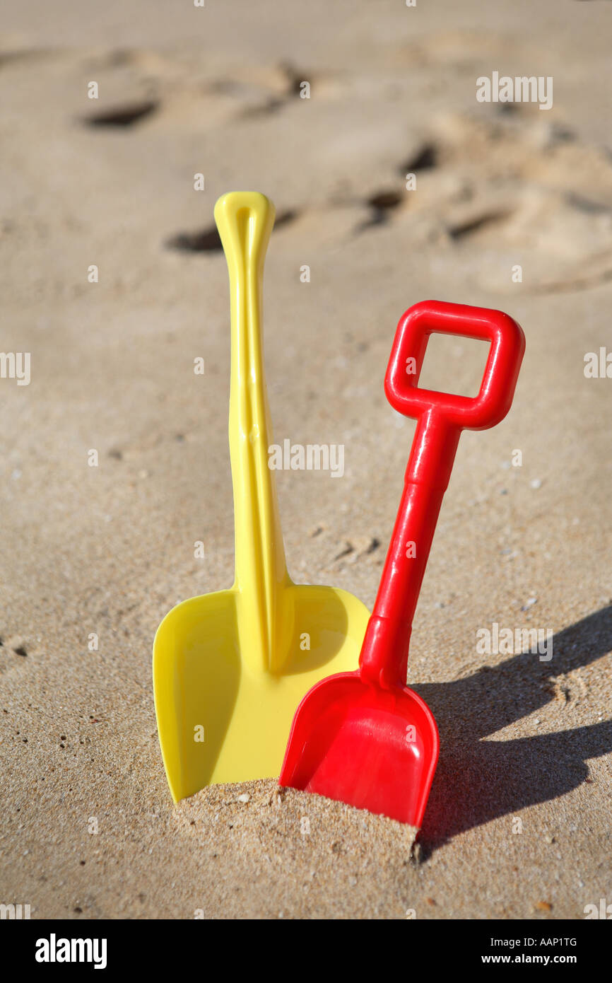 yellow and red beach shovels Stock Photo Alamy