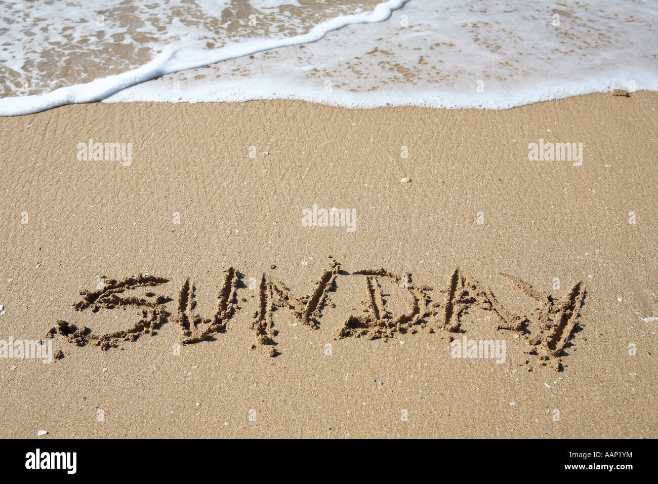 sunday written on sand, weekdays Stock Photo