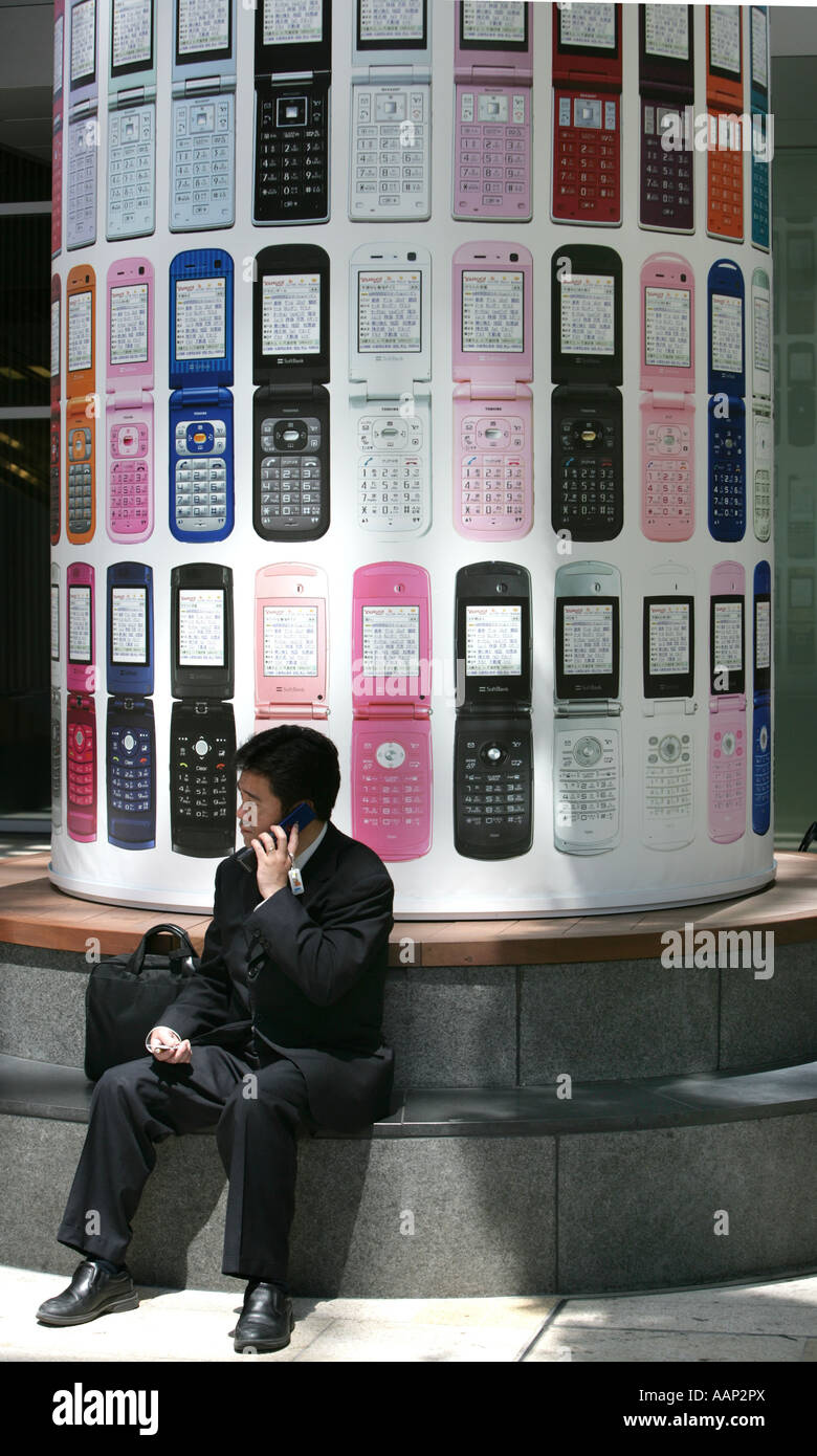 JPN, Japan, Tokyo: Mobile phone user. Billboard of japanese provider Softbank Stock Photo