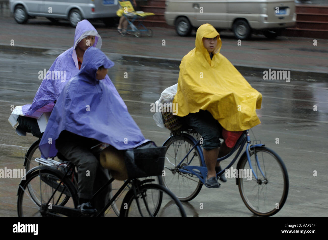 China Shanxi Datong Three Men On Their Bicycle Under The Storm Stock Photo