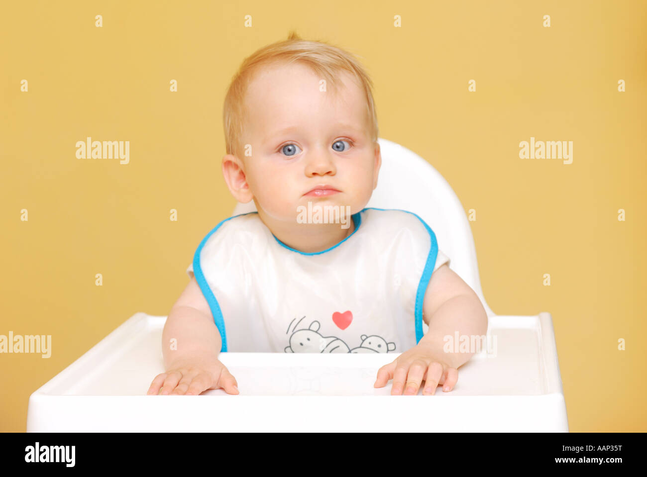 Baby in high chair Stock Photo