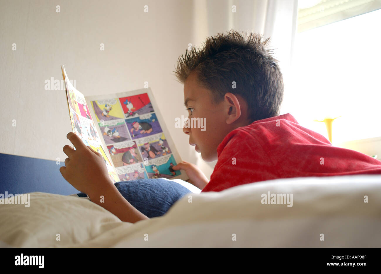 Boy reading comic book Stock Photo