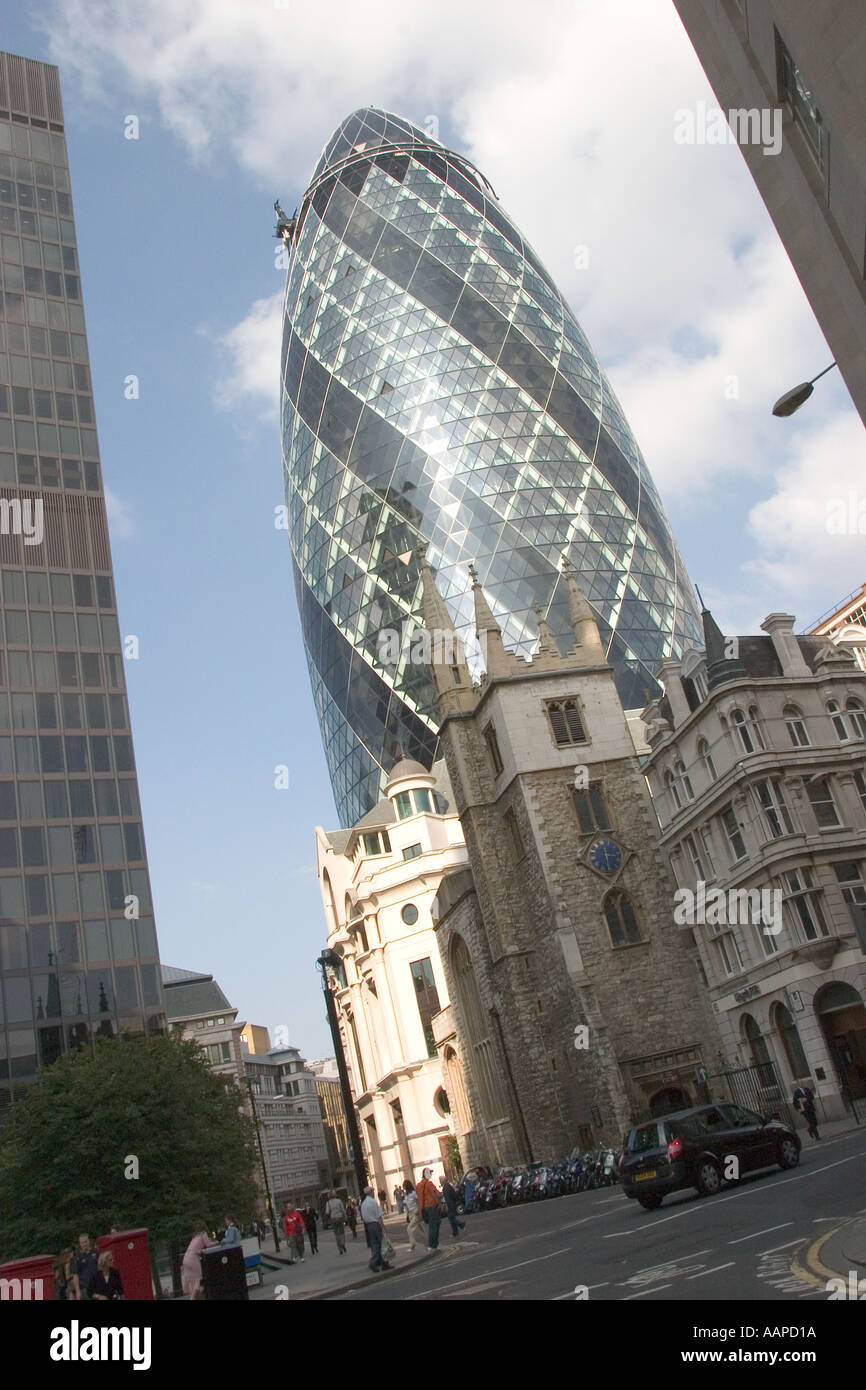 gherkin in the London skyline with small City church in foreground Stock Photo
