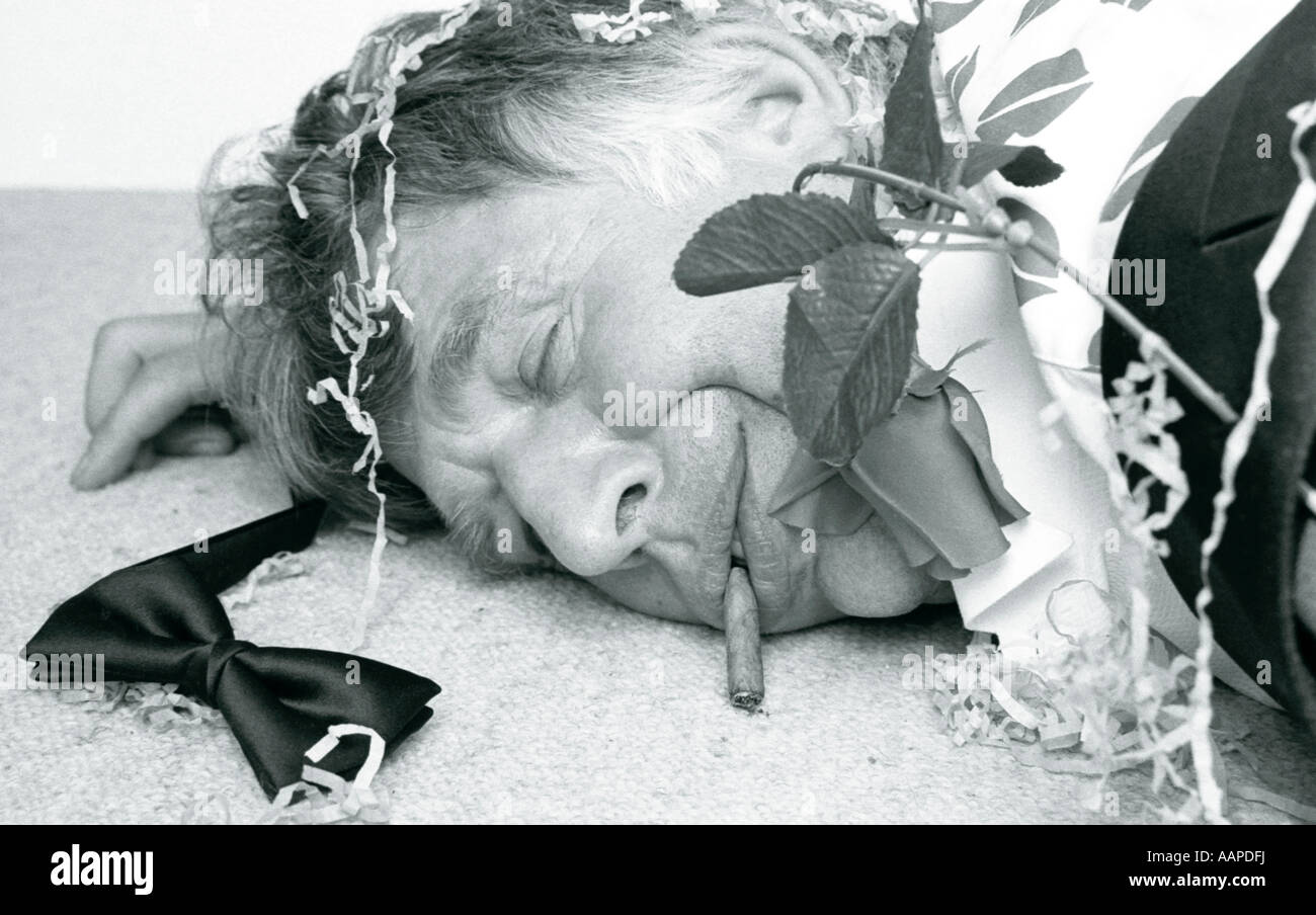 Man asleep on floor after party. Stock Photo