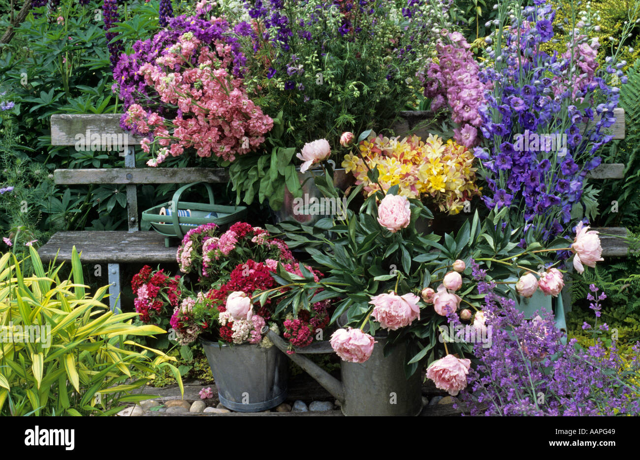 still life of summer cut flowers in buckets containers watering can