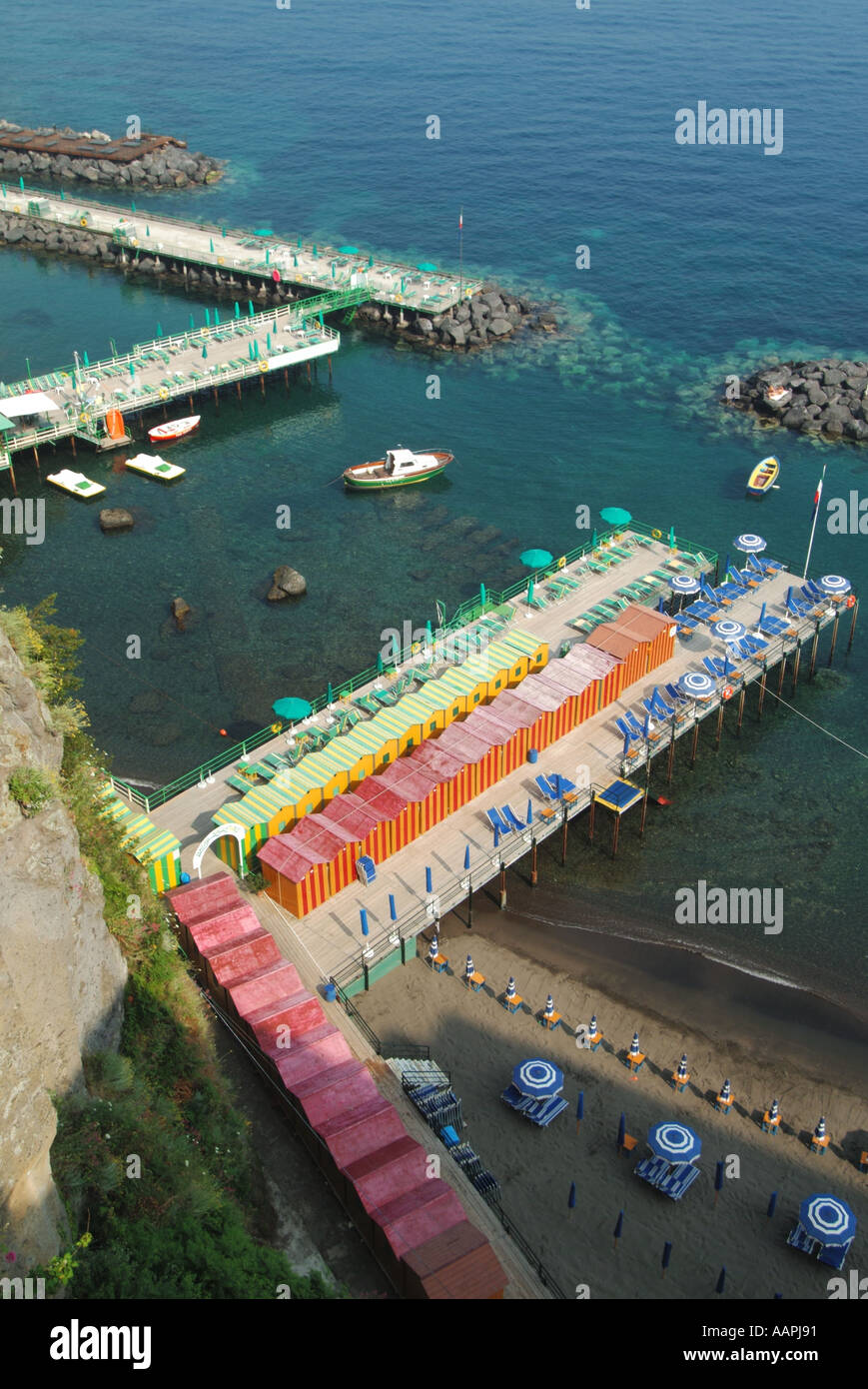 Sorrento coastal resort looking down on prepared waterside sunbathing equipment viewed before the daily influx of sunseekers arrives at Bay of Naples Stock Photo