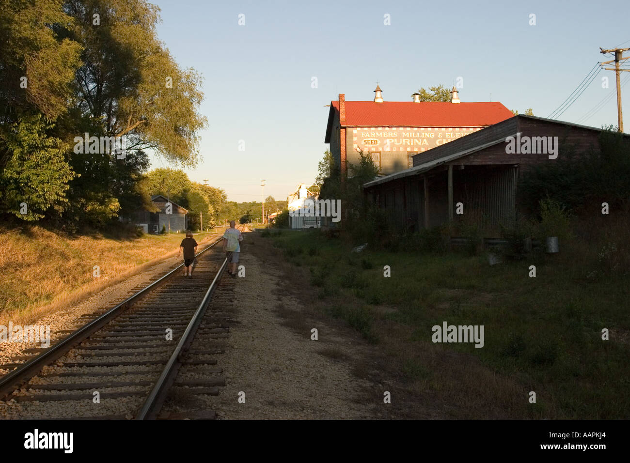Two boys walking on railroad track Palmyra Wisconsin USA Stock Photo