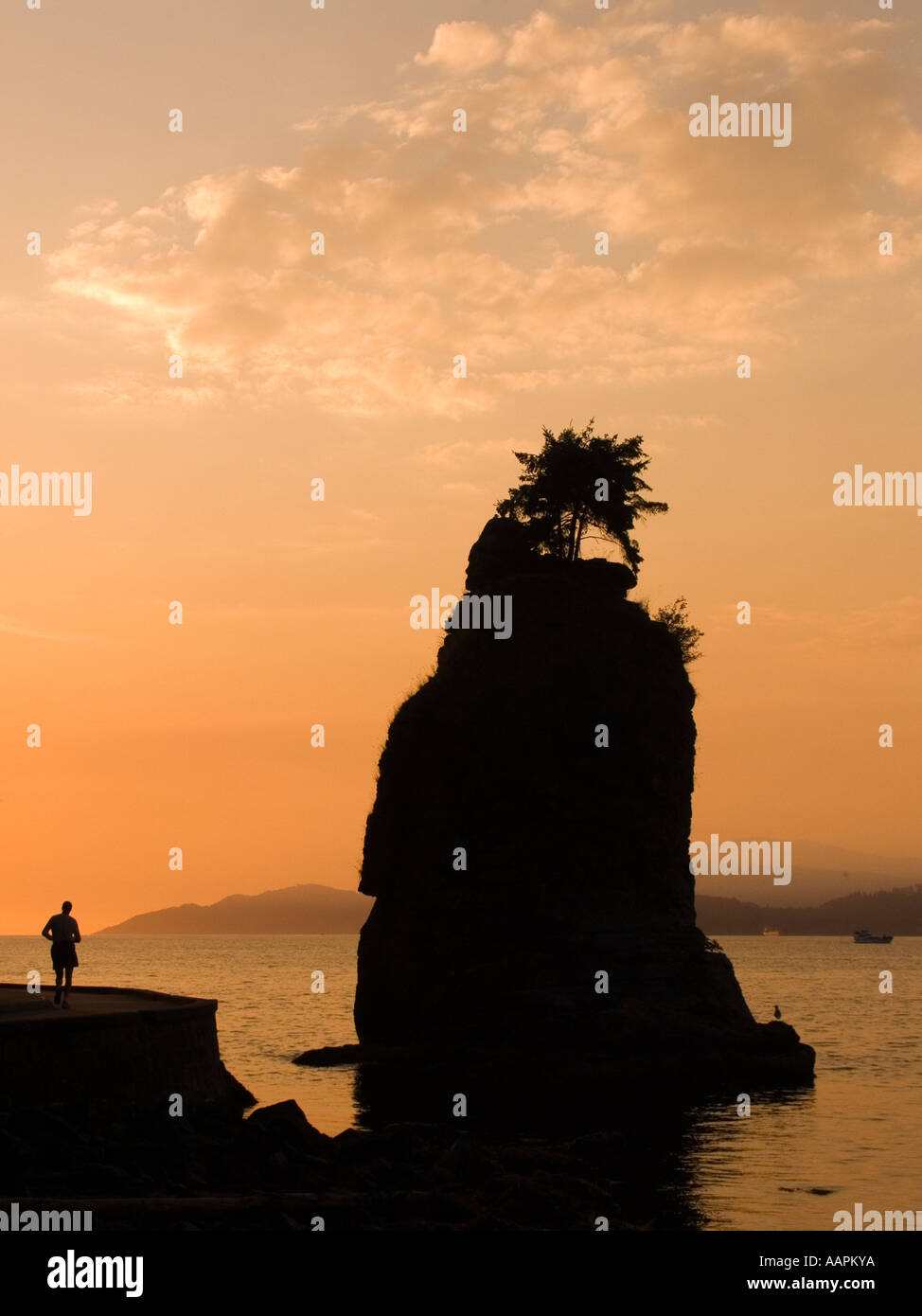 Siwash Rock and jogger Stanley Park Vancouver British Columbia Canada Stock Photo