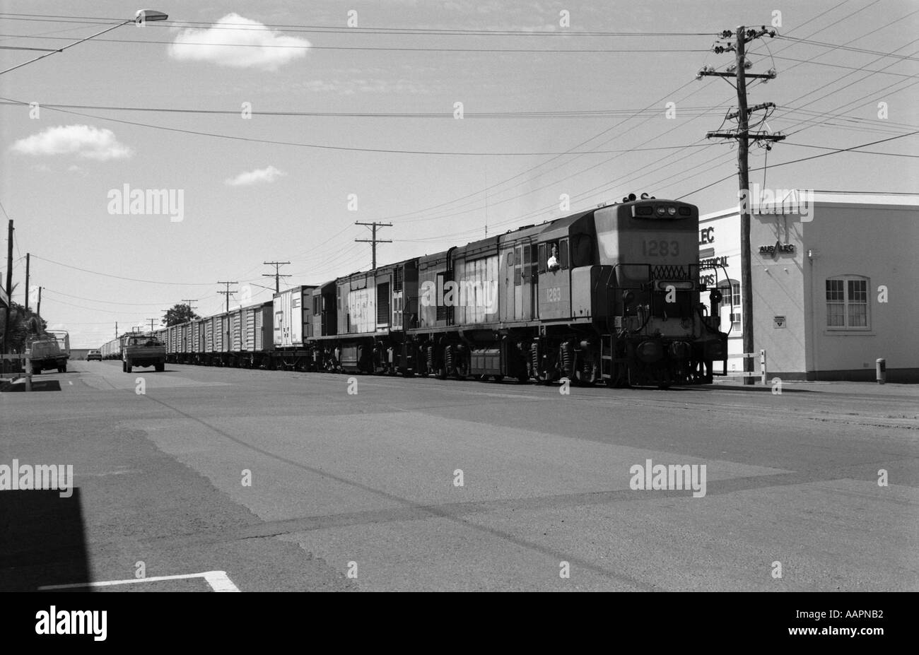 Queensland Railways freight train in main street, Rockhampton, Queensland, Australia. November 1987 Stock Photo