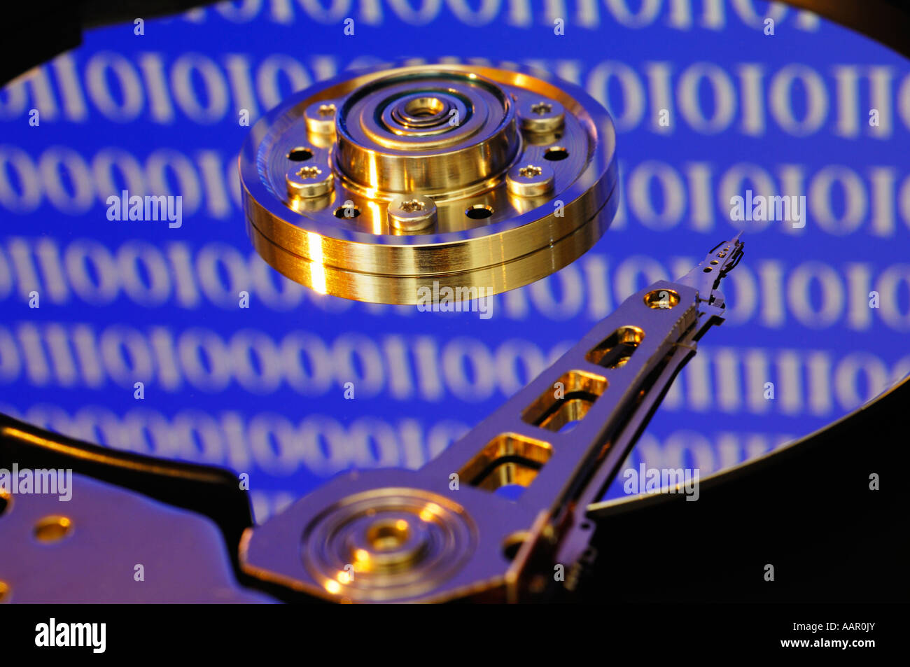 A computer hard disc exposed showing the disc platter, the