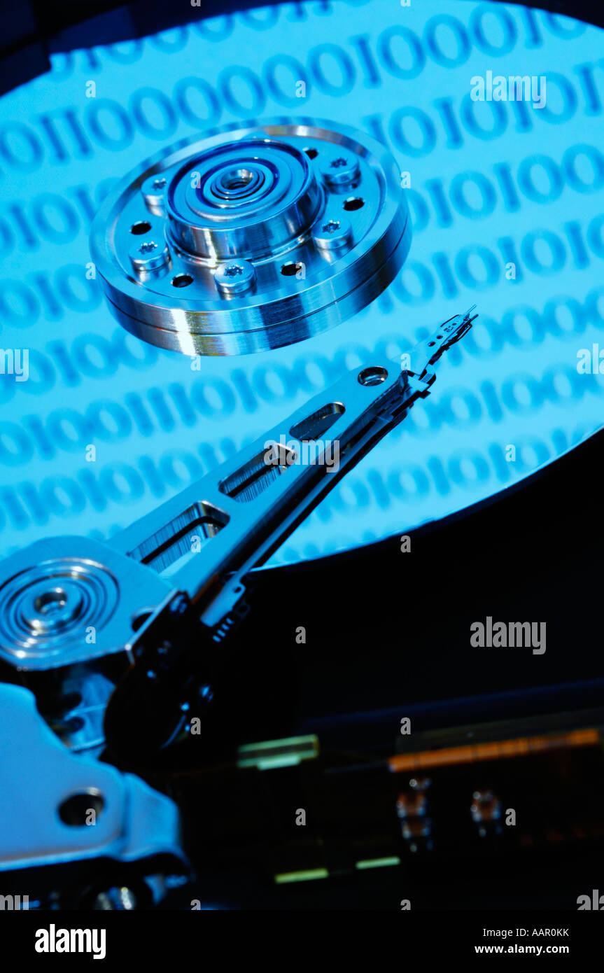 A computer hard disc exposed showing the disc platter, the