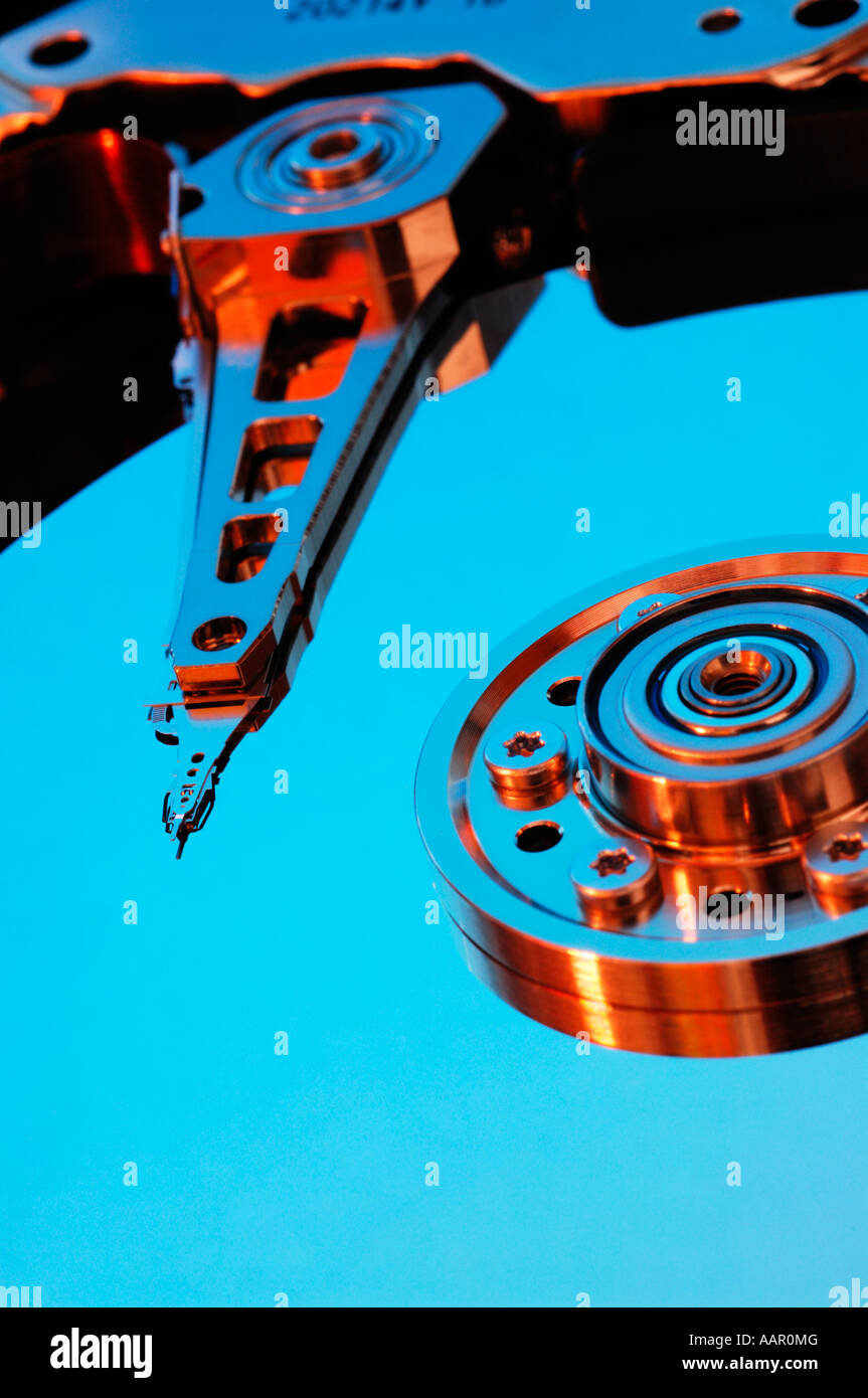 A computer hard disc exposed showing the magnetic disc platter, the read and write head and arm. Stock Photo
