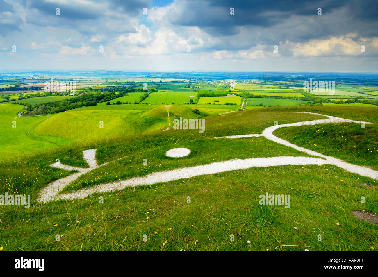 View over the Vale of White Horse, the Uffington White Horse and Dragon Hill from Whitehorse Hill in Oxfordshire, England. Stock Photo
