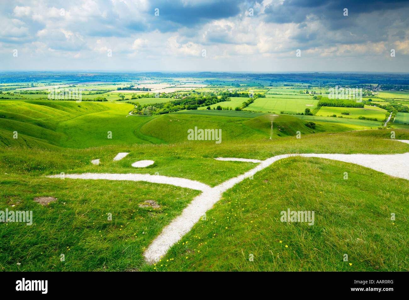 View over the Vale of White Horse, The Manger, Dragon Hill and the Uffington White Horse from Whitehorse Hill in Oxfordshire, England. Stock Photo