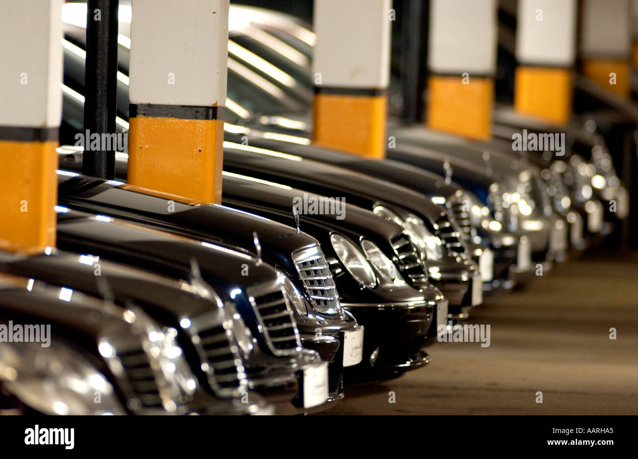 Grilles and bonnets of a fleet of new Mercedes cars in an underground car park in London Stock Photo
