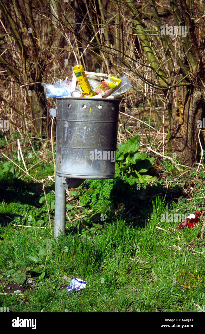 Full trash can along walking path in a forest, Biesbosch National Park