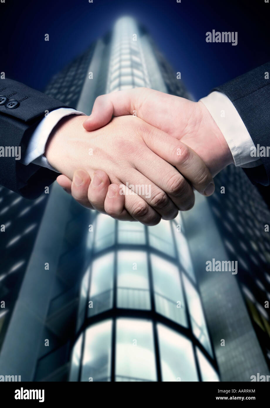 Hand shake with buildings hi-res stock photography and images - Alamy