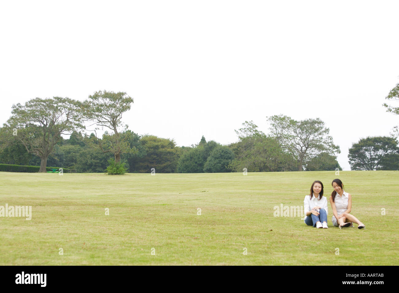 Two young women in park hi-res stock photography and images - Alamy