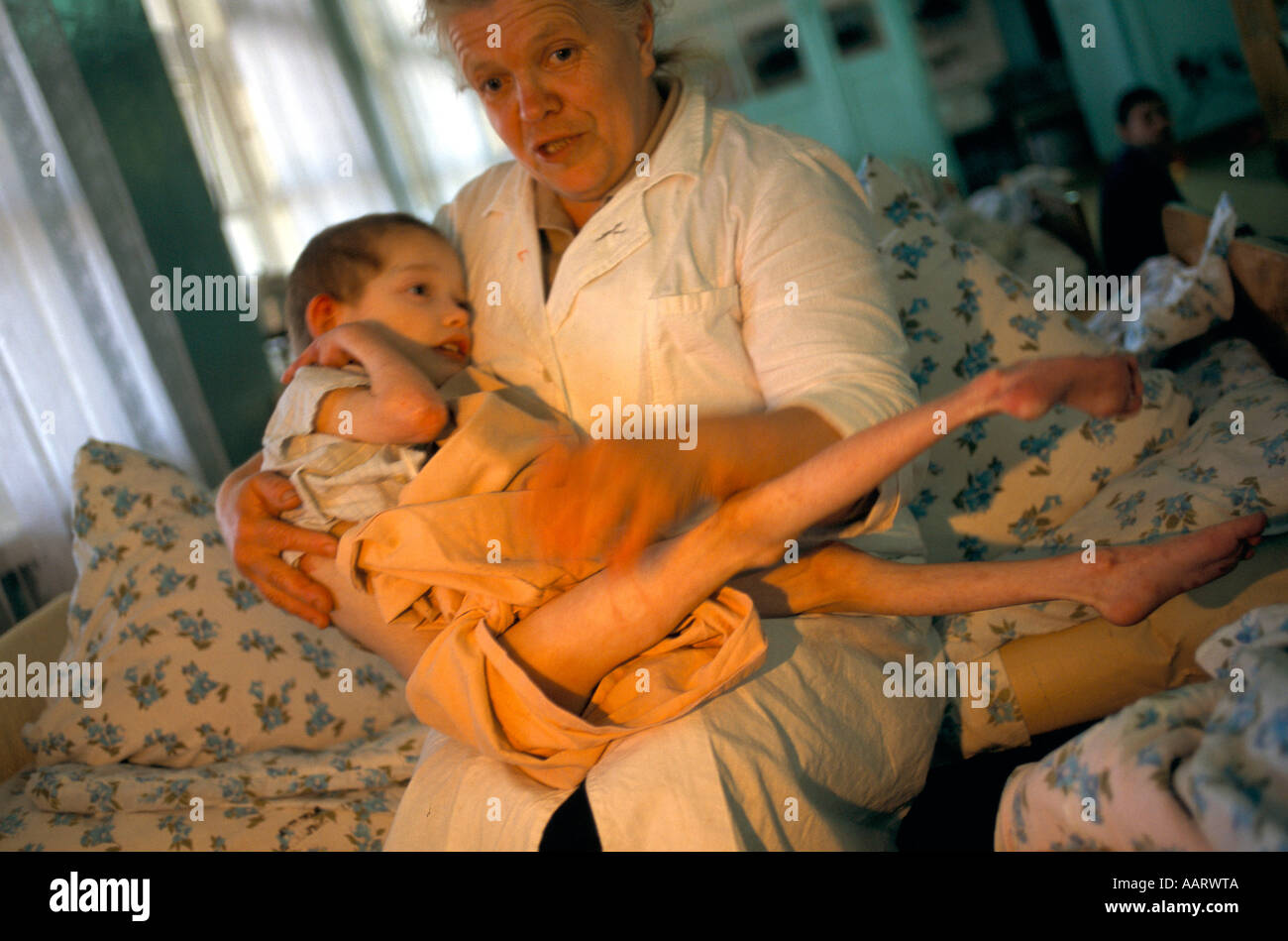 ORPHANAGES IN RUSSIA WOMAN HOLDS A CHILD AT THE OREKHOVO ZUEVO ORPHANAGE THIRTY MILES EAST OF MOSCOW 1996 Stock Photo