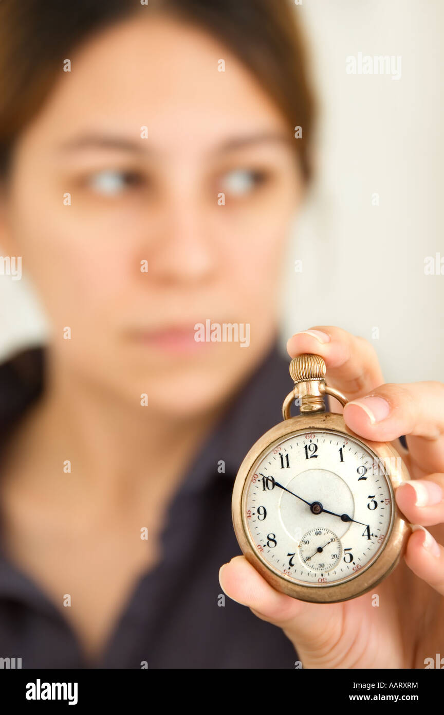 Woman holding up a pocket watch focus on watch Stock Photo Alamy