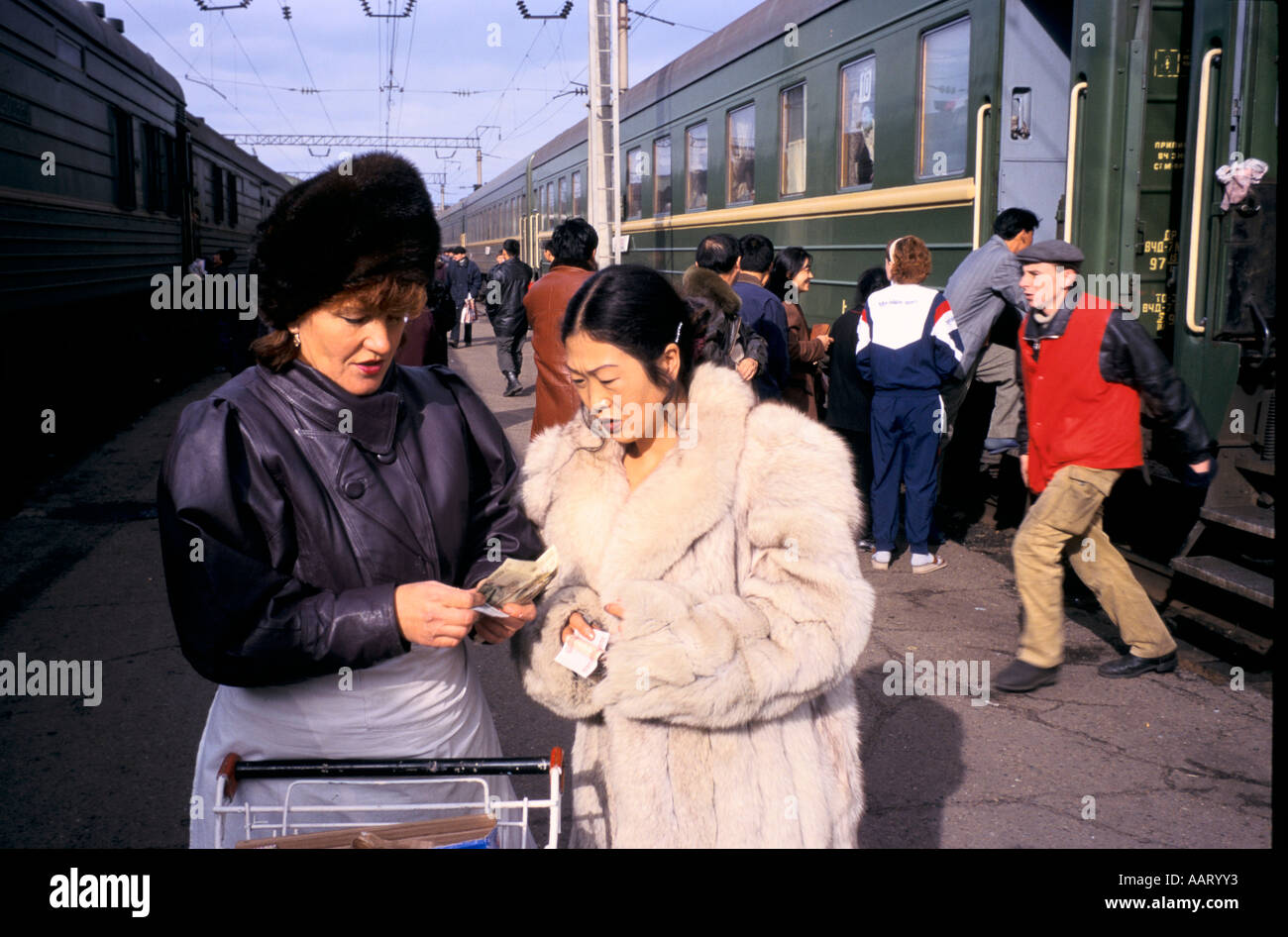 TRANS SIBERIAN RAIL JOURNEY CHINESE WOMAN CHANGING MONEY AT STATION ULAN UDE 1997 Stock Photo
