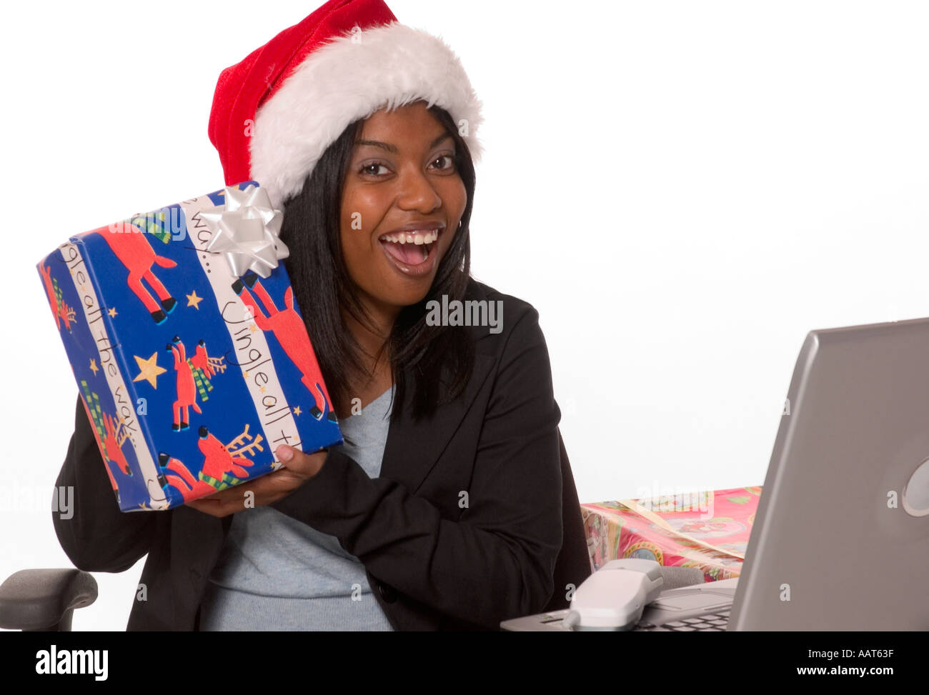 Businesswoman in Santa hat smiles and shows Christmas gift. USA Stock Photo