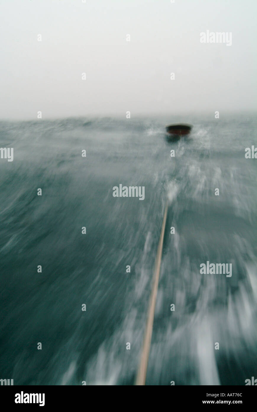 a dingy being towed behind a sailboat in the Atlantic Stock Photo