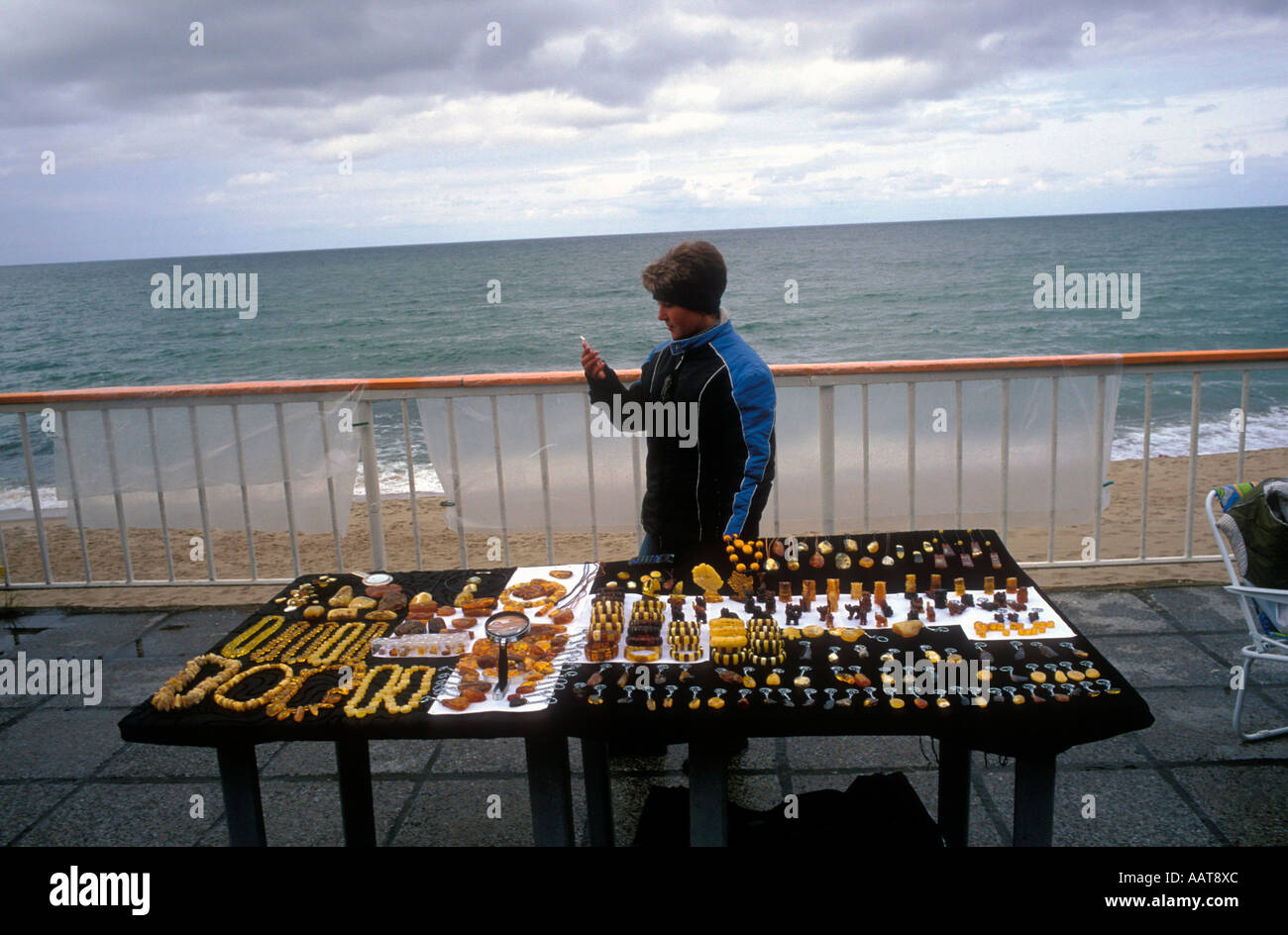 A girl selling locally crafted amber jewelery to foreign tourists Stock Photo