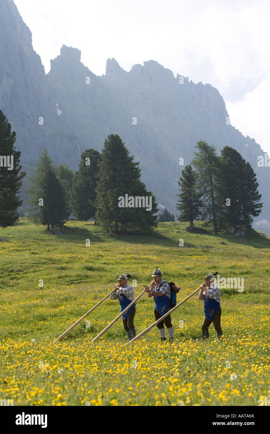 Playing the alpenhorn in the Dolomites, Italy Stock Photo