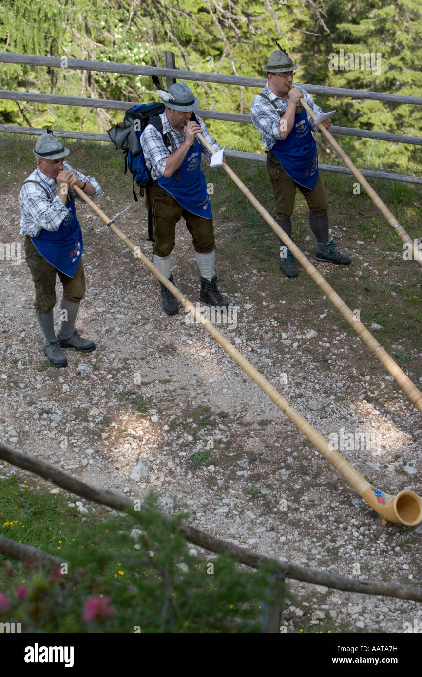 Playing the alpenhorn in the Dolomites, Italy Stock Photo