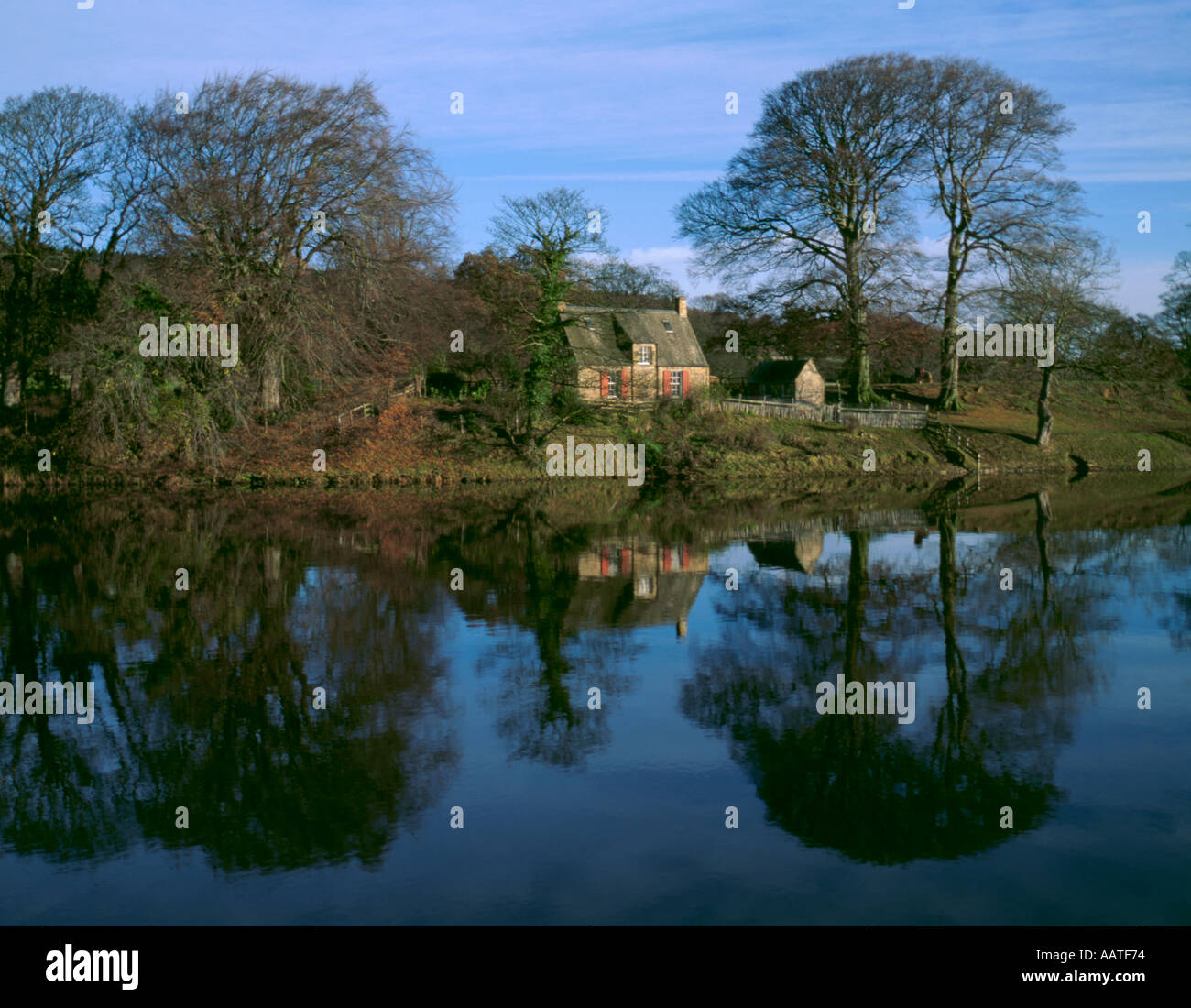 House on a river bank; pretty cottage seen over the River Tyne near Hexham,  Northumberland, England, UK Stock Photo - Alamy
