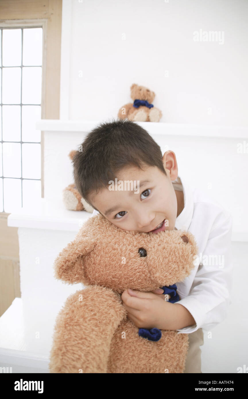 Boy cuddling Teddy Bear Stock Photo Alamy