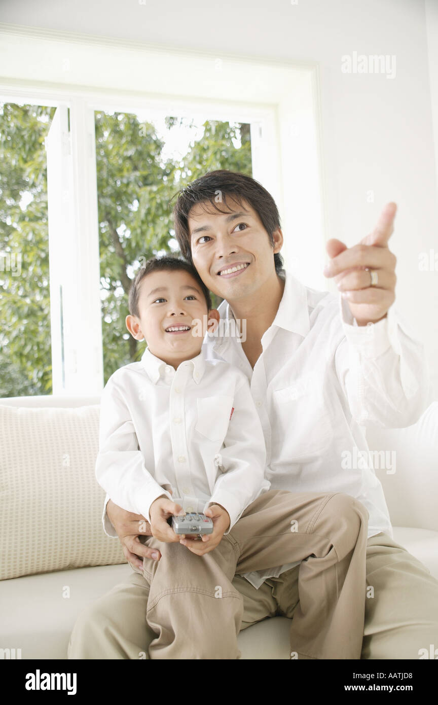 Child sitting on fathers lap hi-res stock photography and images - Alamy