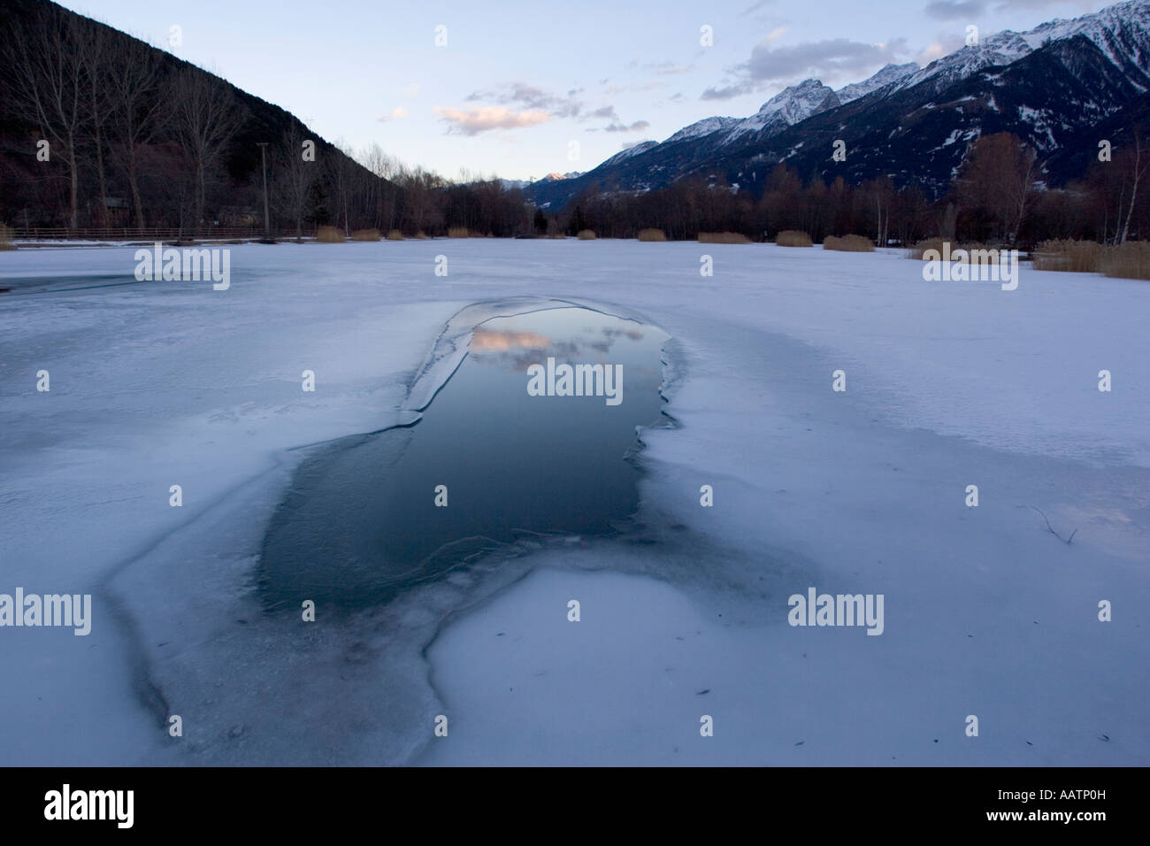 Frozen fishing lake, Spondigna (Spondinig), Alto Adige, Italy, Europe