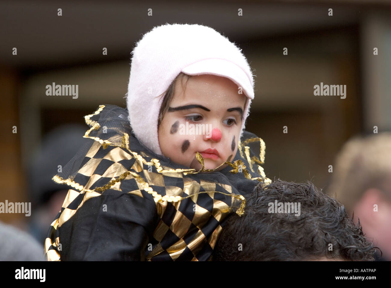 Child on shoulders, at the traditional carnival of "maschger umzug" in Prad, South Tyrol, Italy Stock Photo