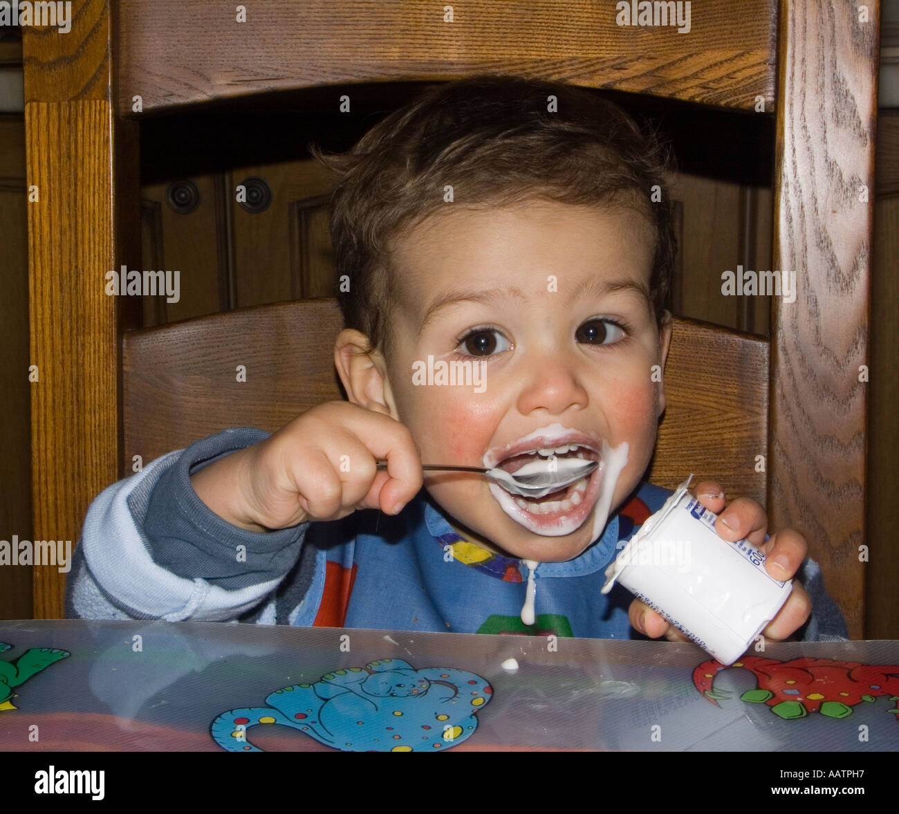 Toddler eating yogurt Stock Photo Alamy