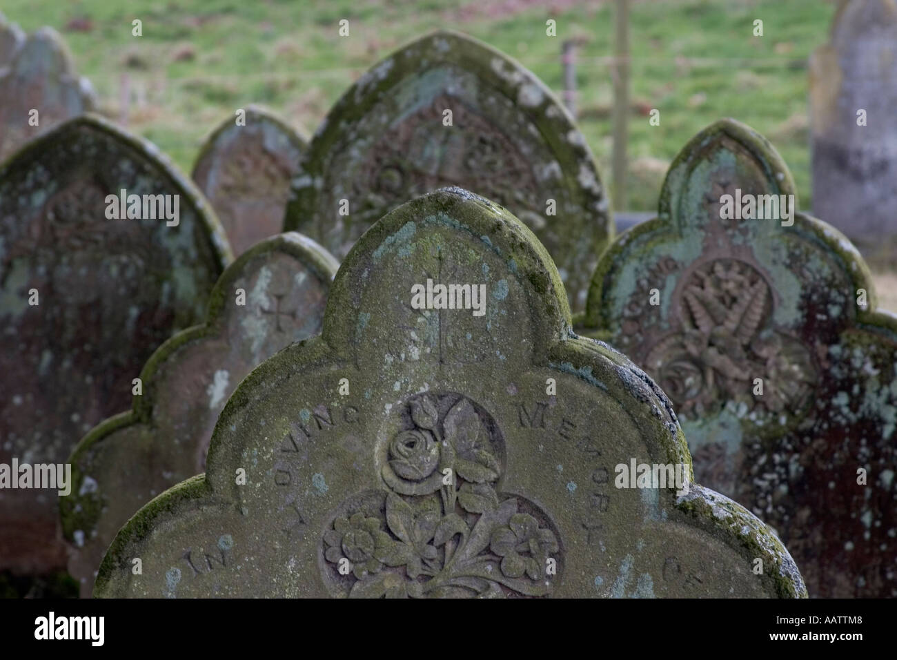 An unidentified set of gravestones in a non-dispirit English rural grave yard. Stock Photo