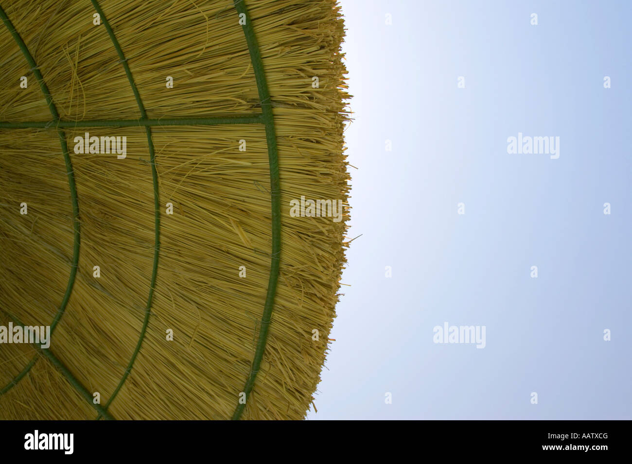 edge of straw parasol protecting against harmful UV rays from the sun