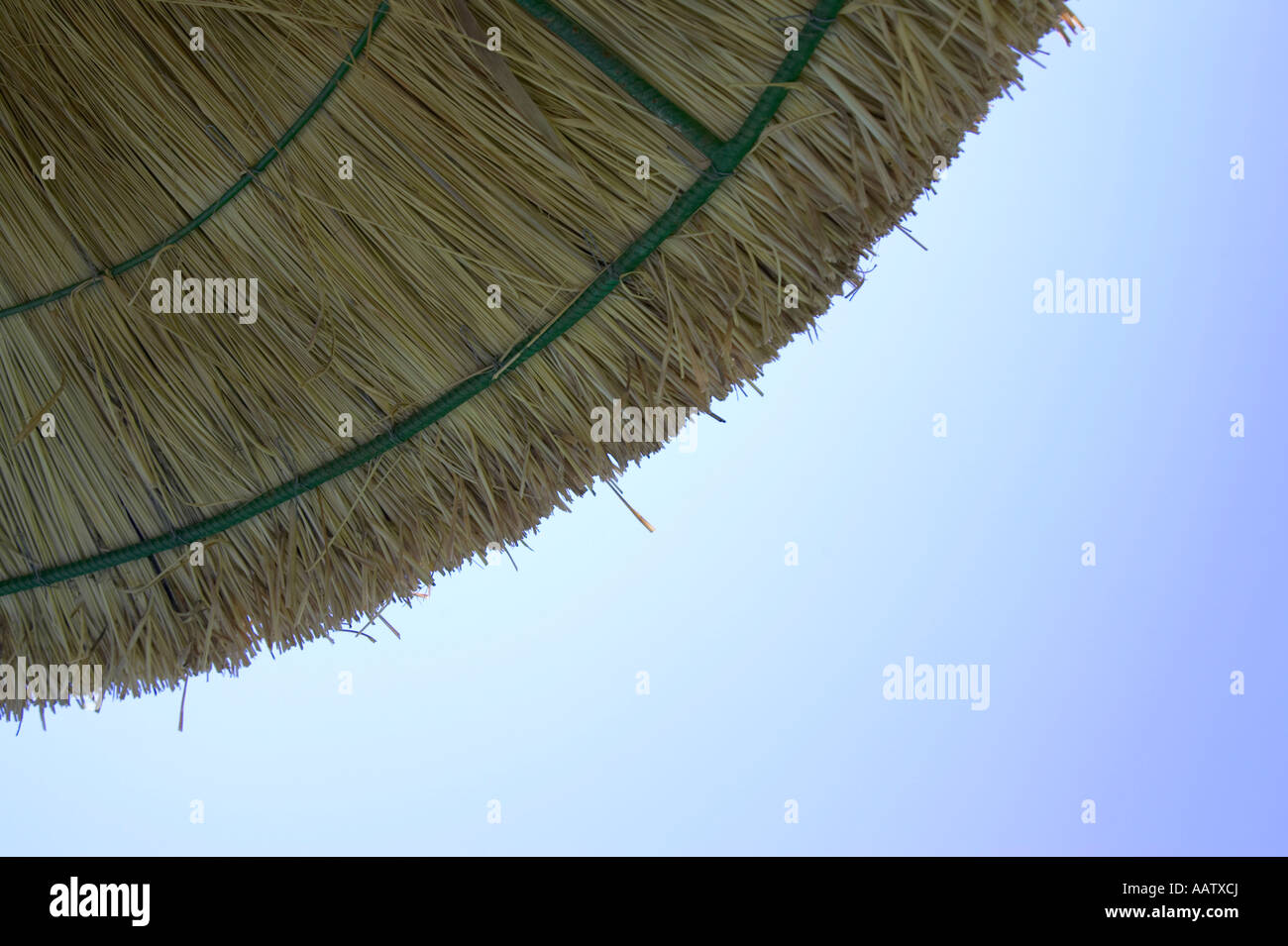 straw parasol protecting against harmful UV rays from the sun with blue