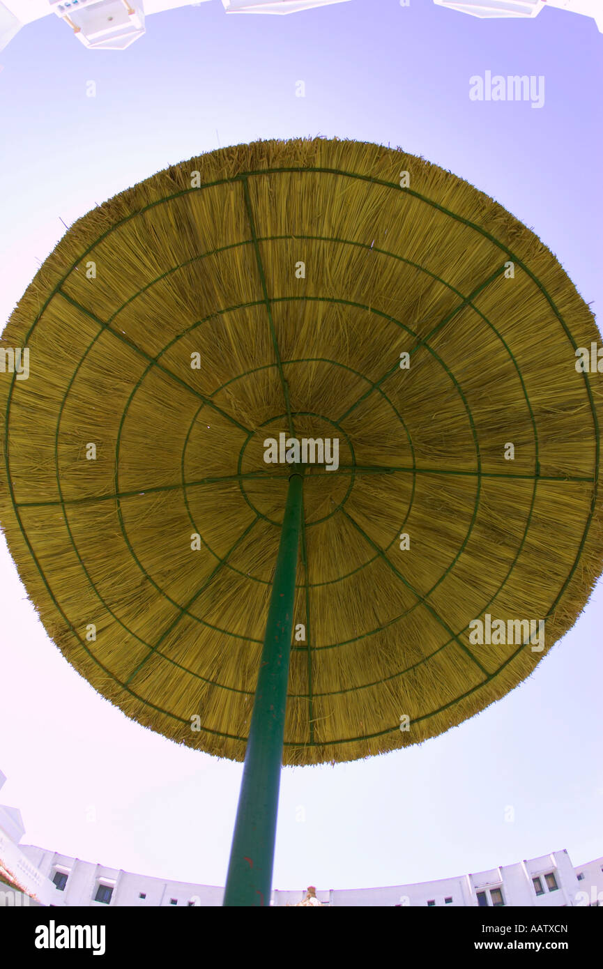 straw parasol protecting against harmful UV rays from the sun in the