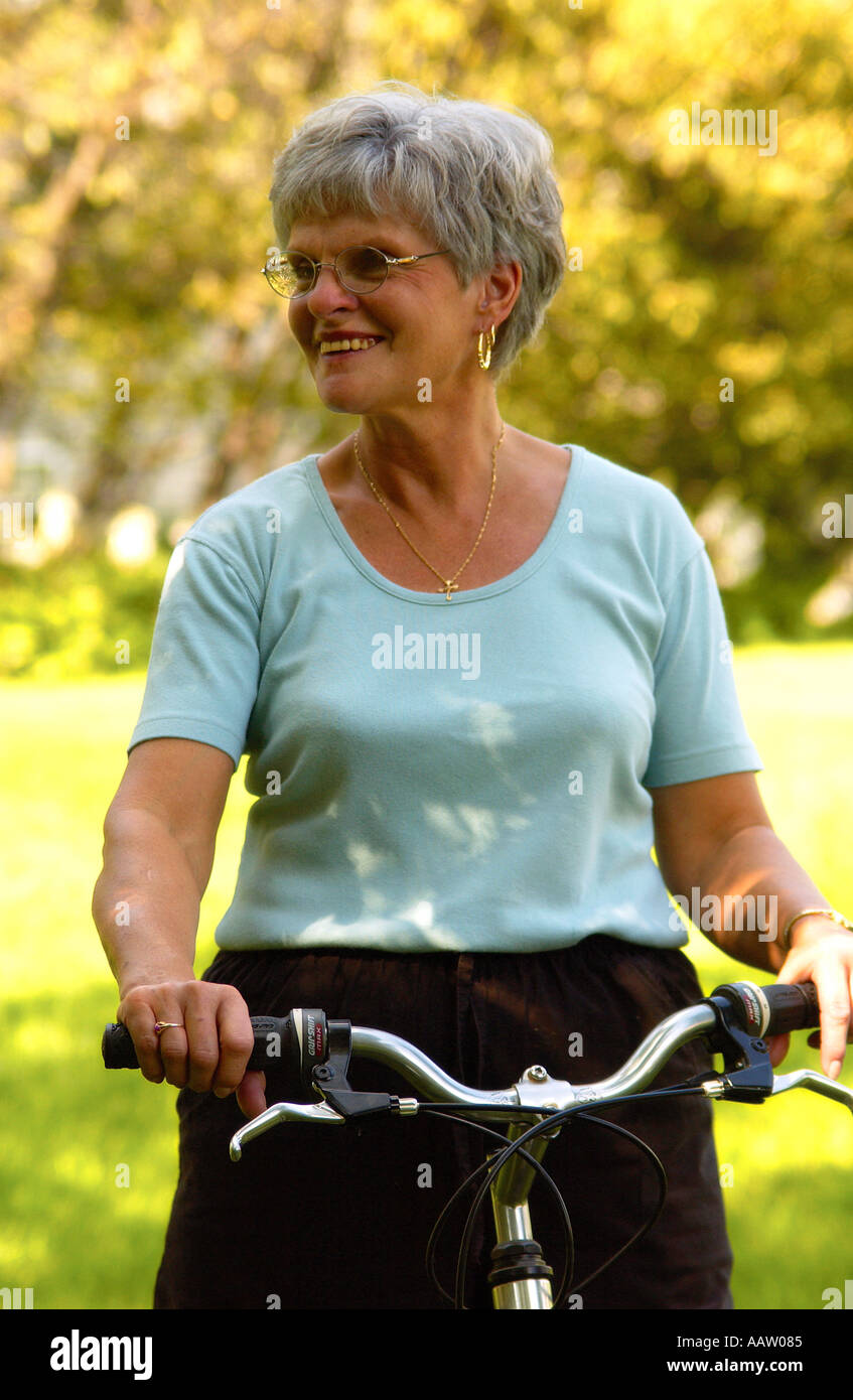 Senior woman riding bicycle Stock Photo - Alamy