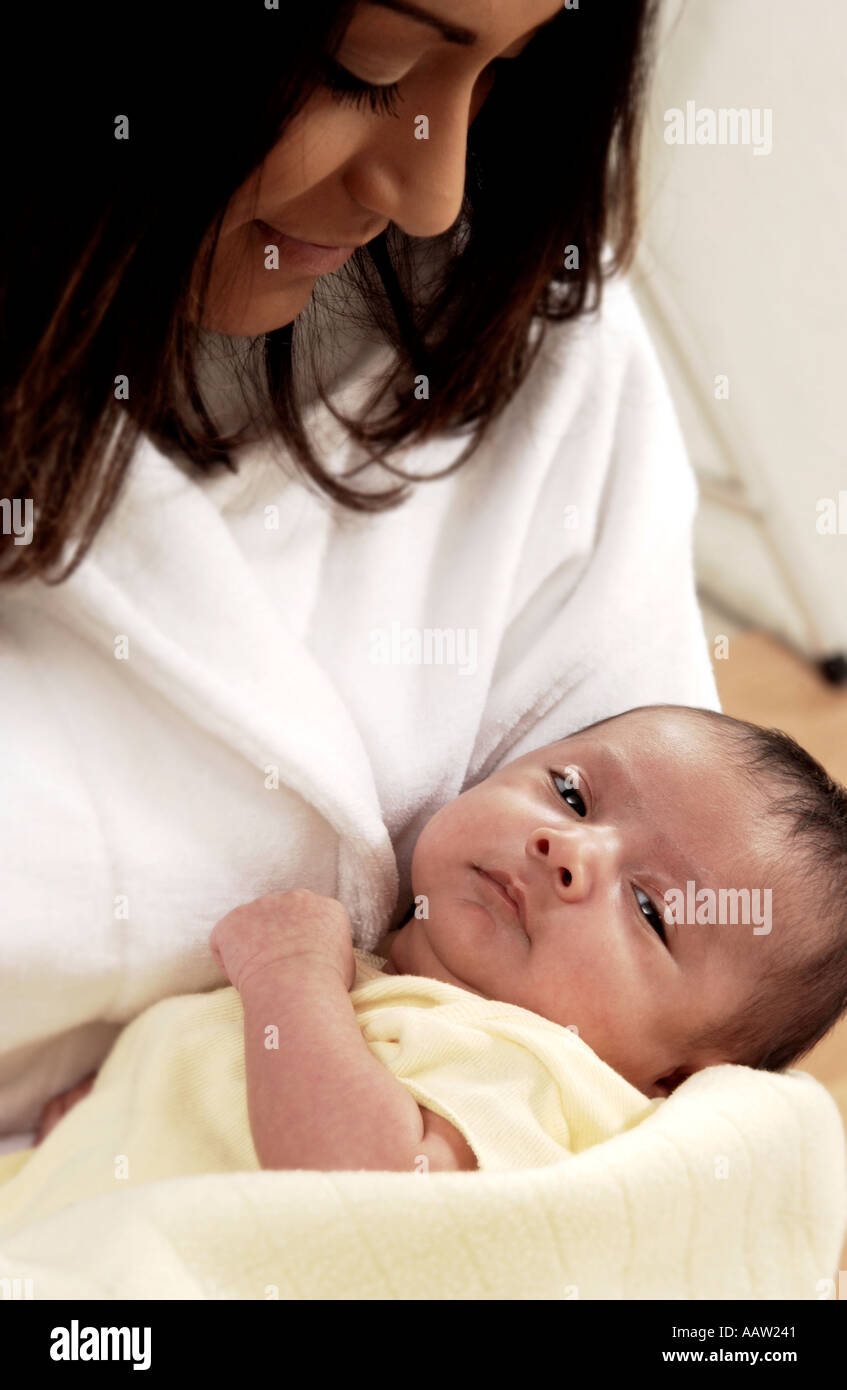 Hispanic mother holding infant Stock Photo