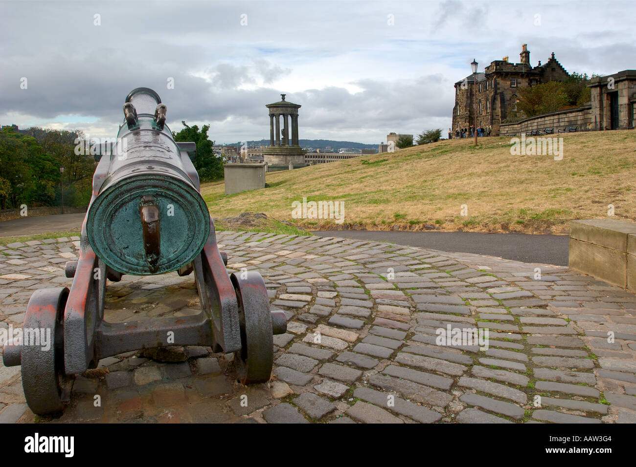 Commemorative cannon atop Calton Hill Edinburgh with The Dugald Stewart Monument in front and distant views over the city Stock Photo