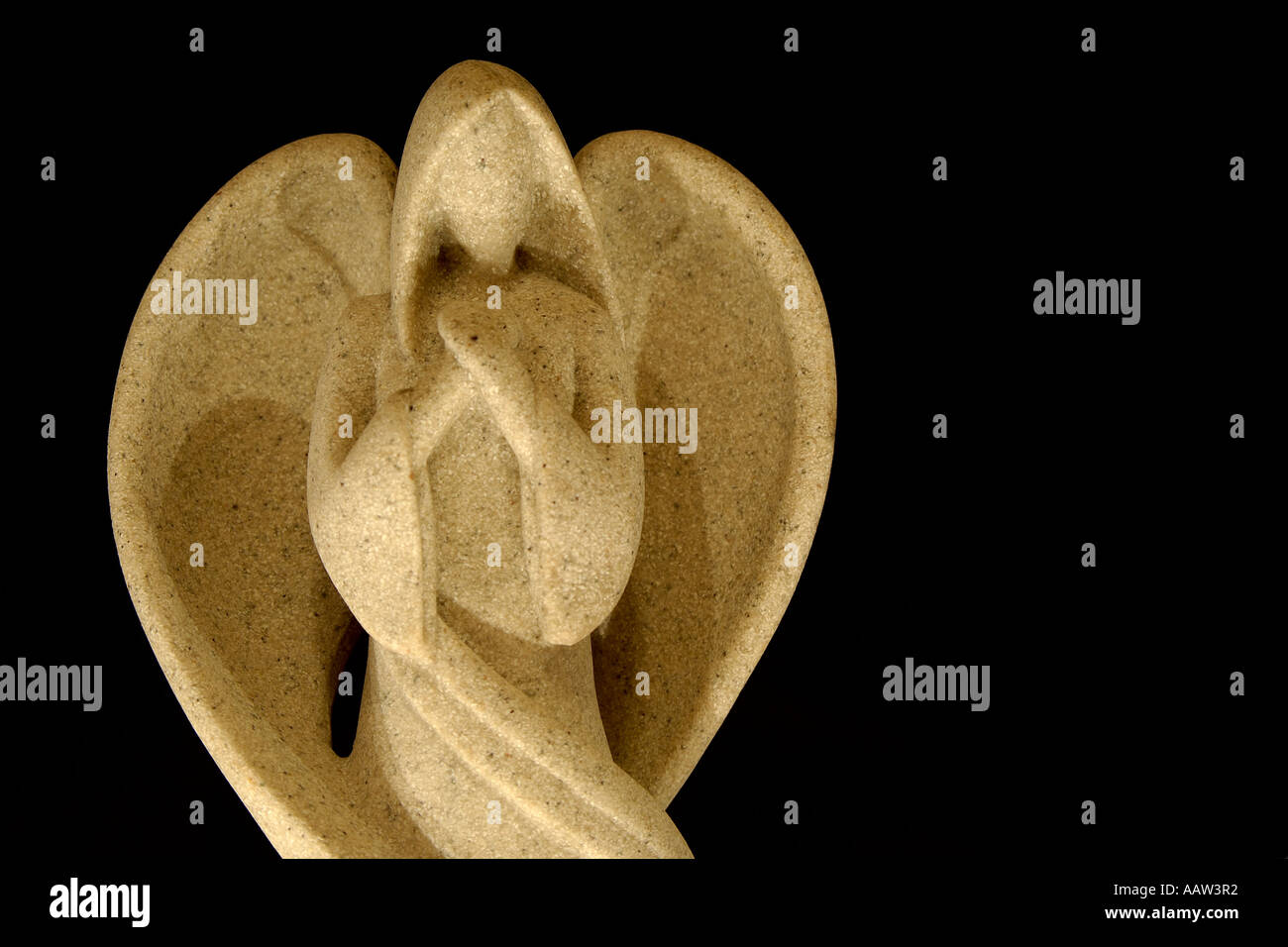 Close up offset image of faceless Christmas angel decoration on a plain pure black background with plenty of room for text Stock Photo