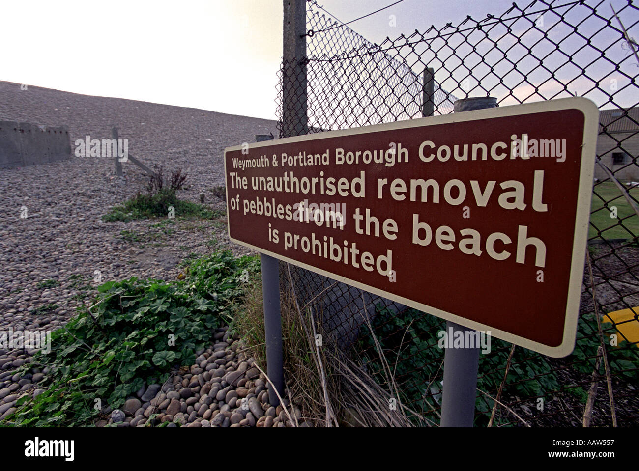 The unauthorised removal of pebbles from the beach is prohibited sign ...