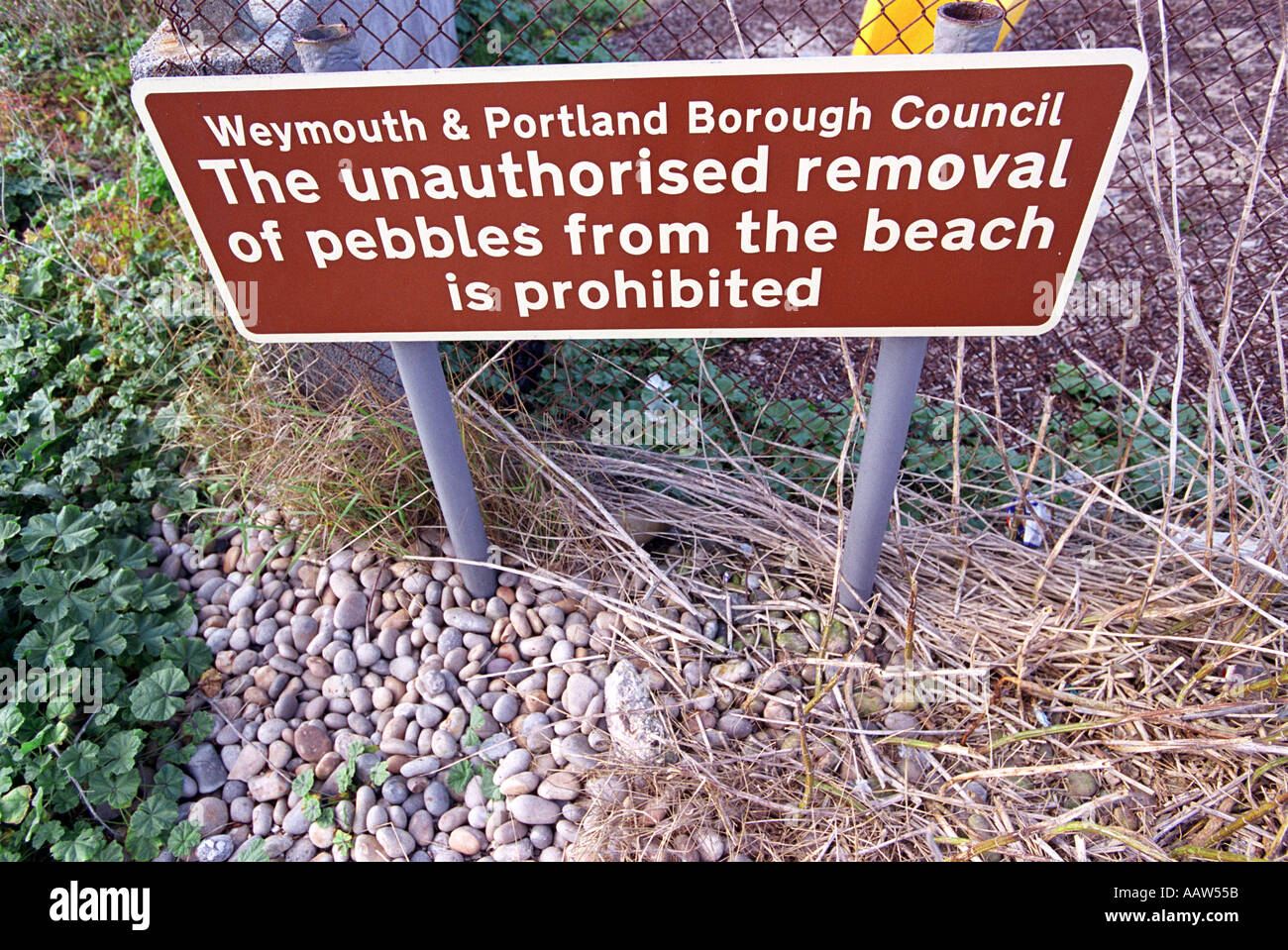 The unauthorised removal of pebbles from the beach is prohibited sign ...