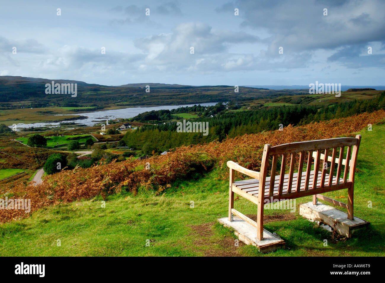 Lovely bright sunny landscape image of a public bench overlooking villages of Kilmore and Dervaig on Isle of Mull Stock Photo