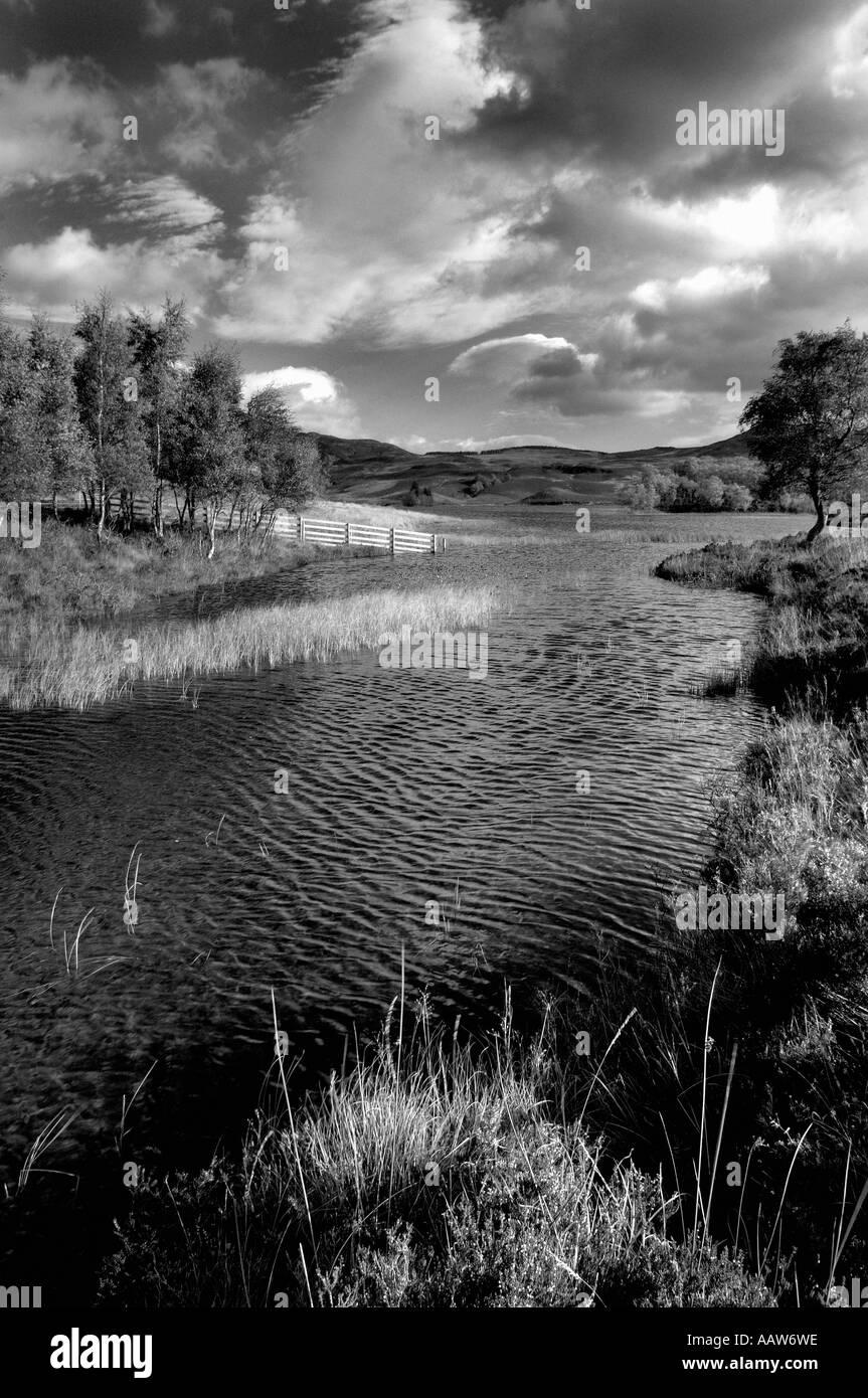 Tranquil high contrast monochrome image of Loch Tarff in the Scottish highlands Stock Photo