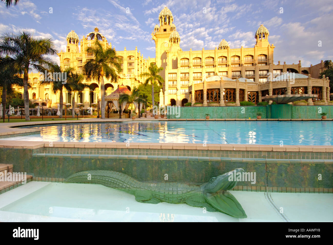 A dawn view of the swimming pool outside the Palace of the Lost City hotel in the Sun City resort in South Africa. Stock Photo
